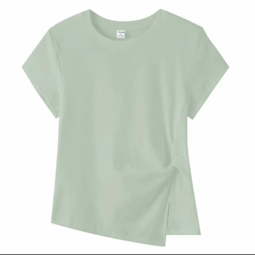 Joyjocey Classic Side-Knot Cotton T-Shirt in light sage green with an asymmetrical hem and side slit.