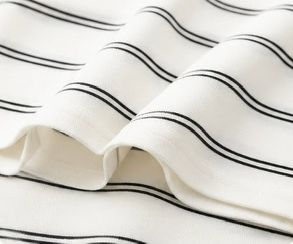 Soft draped hem and black horizontal stripe detail on the white Joyjocey Relaxed Striped Long-Sleeve Top.