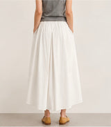 Back view of a model wearing the creamy white Joyjocey High-Waist Pleated A-Line Skirt.