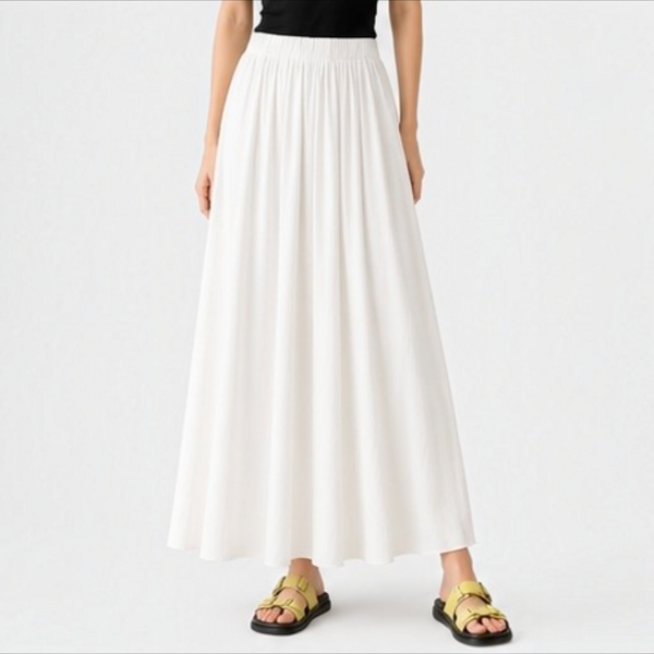 Model wearing the creamy white Joyjocey High-Waist Pleated A-Line Skirt with a flowy maxi-length silhouette, front view.