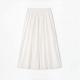Joyjocey High-Waist Pleated A-Line Skirt in creamy white with an elastic waistband and flowy maxi hem, product front view.