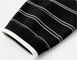 White-trimmed cuff and horizontal stripe detail on the black Joyjocey Relaxed Striped Long-Sleeve Top.