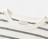 Round neckline and thin black stripe detail on the white Joyjocey Relaxed Striped Long-Sleeve Top.