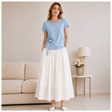 Model wearing the light blue Joyjocey Side-Tie Cotton Top with a white maxi skirt, front view.