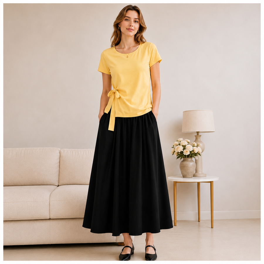 Model wearing the lemon yellow Joyjocey Side-Tie Cotton Top with a black maxi skirt, front view.